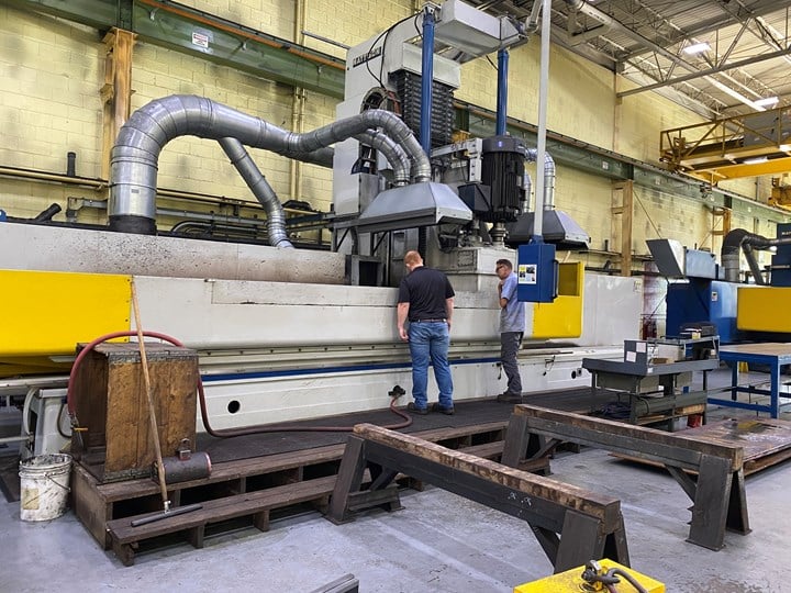 industrial equipment in warehouse with workers